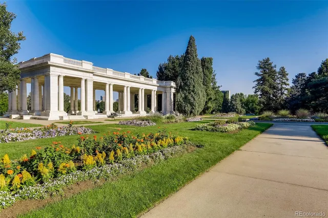 a kitchen with a sink a counter top space stainless steel appliances and cabinets