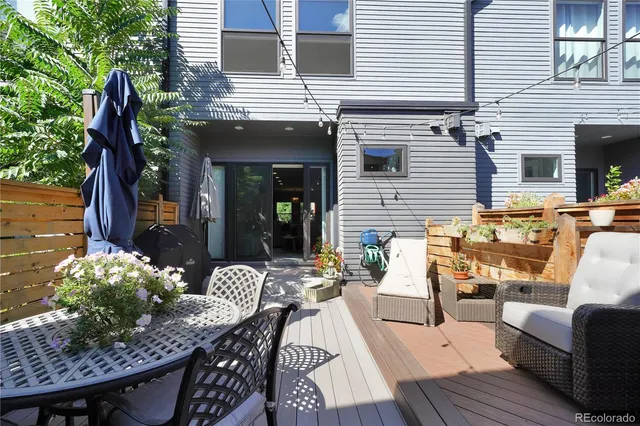 a view of a patio with couches table and chairs and potted plants