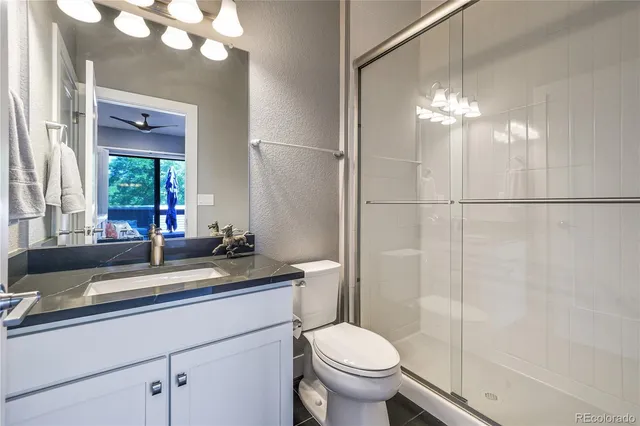 a living room with furniture a flat screen tv and a large window