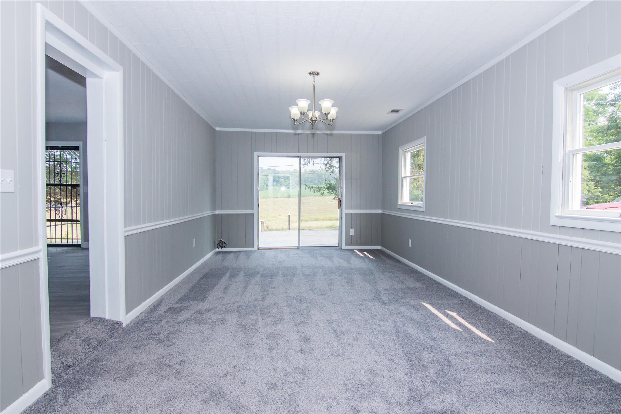 4133 Oak Ridge Road Mount Crawford, VA 22841 - Photo 15 of 30 an empty room with windows and chandelier