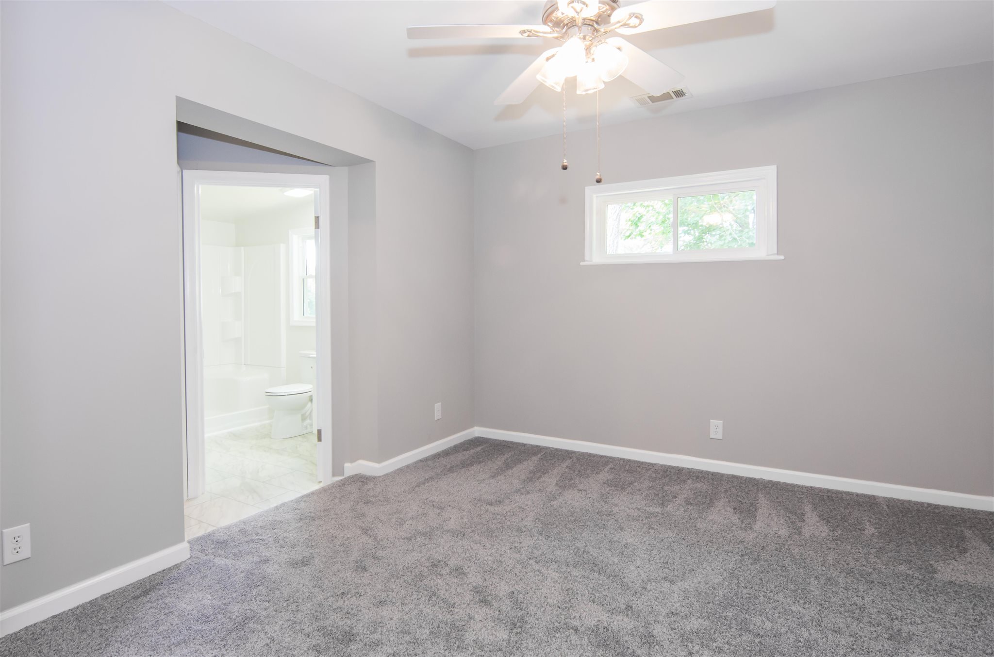 4133 Oak Ridge Road Mount Crawford, VA 22841 - Photo 19 of 30 an empty room with a chandelier fan and windows