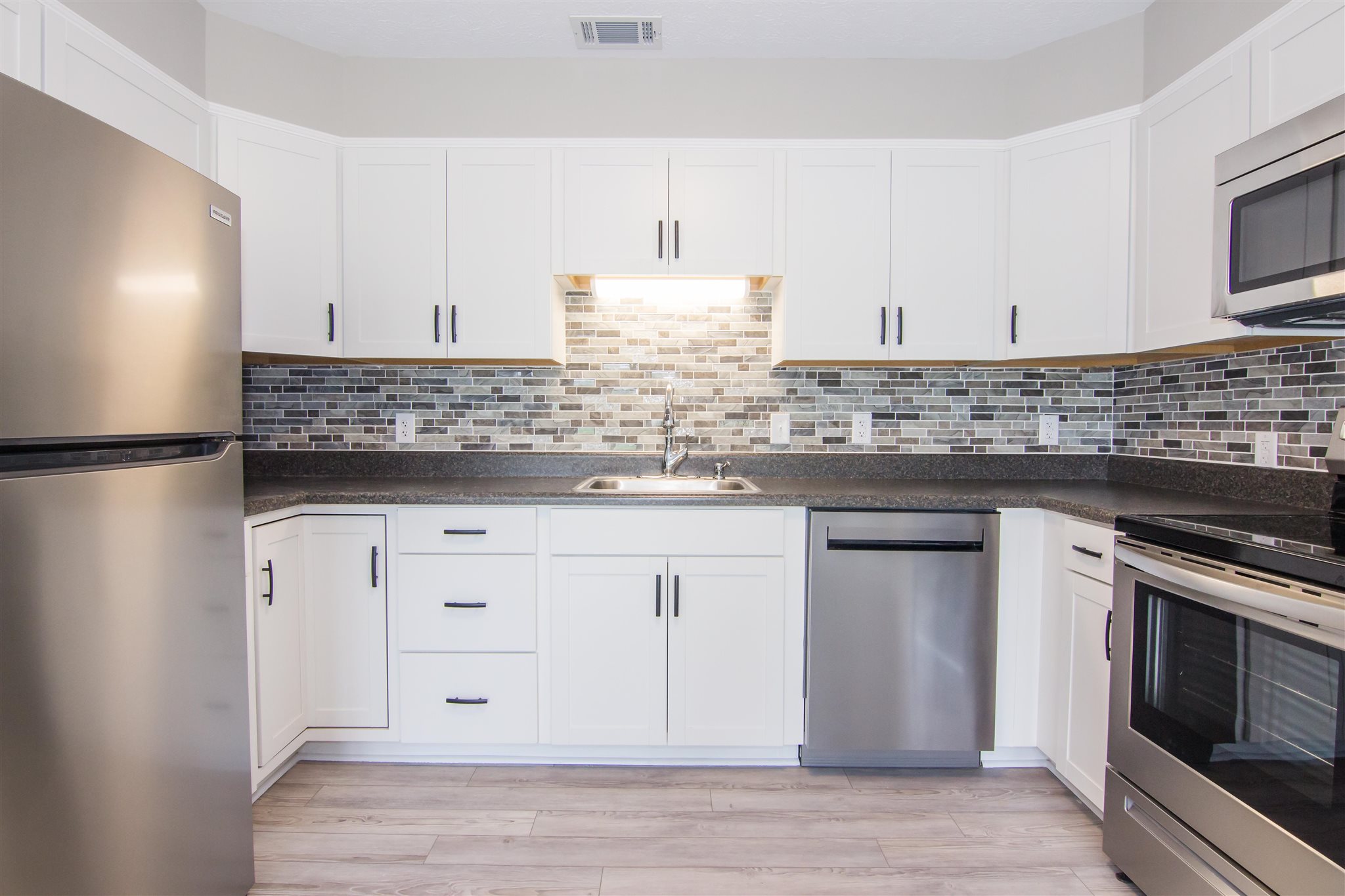 4133 Oak Ridge Road Mount Crawford, VA 22841 - Photo 10 of 30 a kitchen with granite countertop white cabinets and white appliances