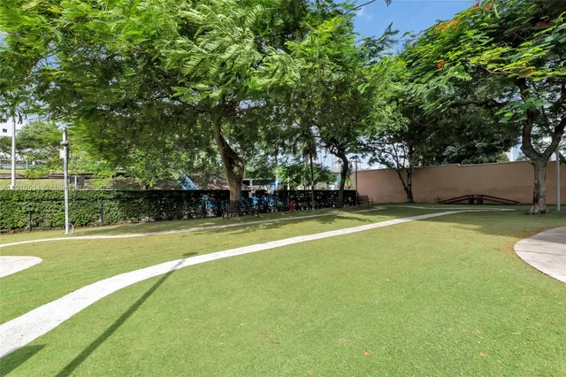 a view of a park with large trees