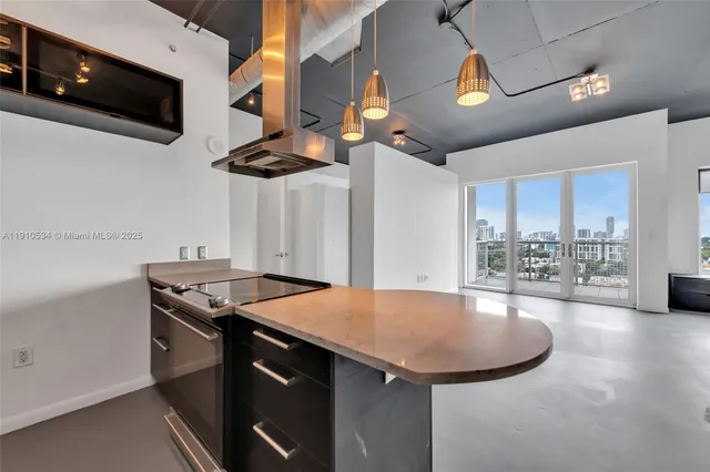 a kitchen with stainless steel appliances granite countertop a sink and a stove