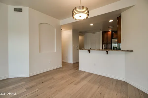 a view of a room with wooden floor and window