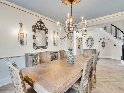 a view of a dining room with furniture and chandelier