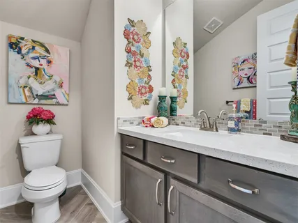a bathroom with a sink mirror and toilet