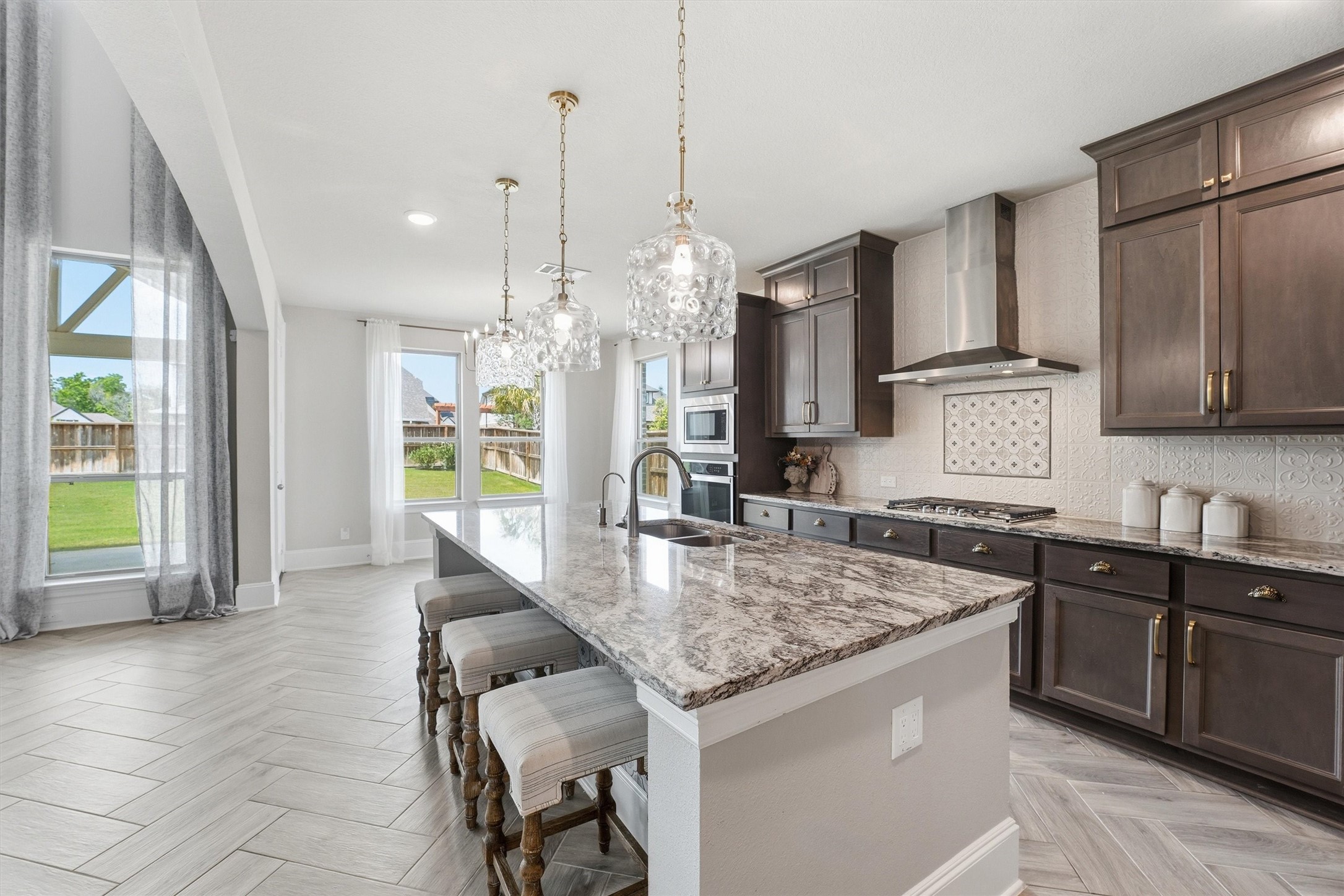 8673 Burdekin Road Magnolia, TX 77354 - Photo 15 of 50 a kitchen with kitchen island granite countertop a sink a counter top space appliances and cabinets