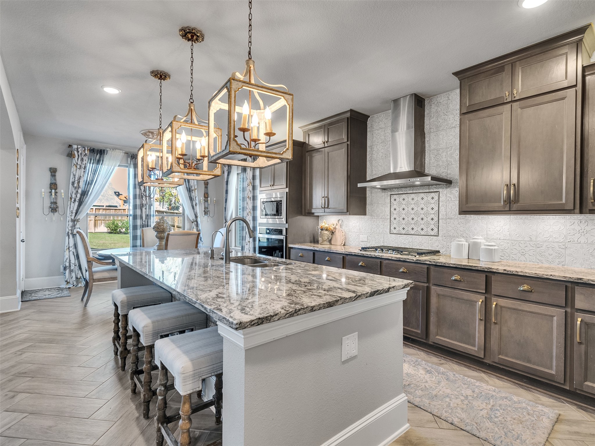 8673 Burdekin Road Magnolia, TX 77354 - Photo 17 of 48 a kitchen with stainless steel appliances granite countertop a sink a stove and a wooden floors