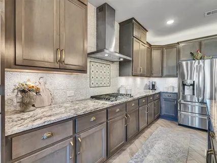 a kitchen with stainless steel appliances granite countertop a sink stove and refrigerator