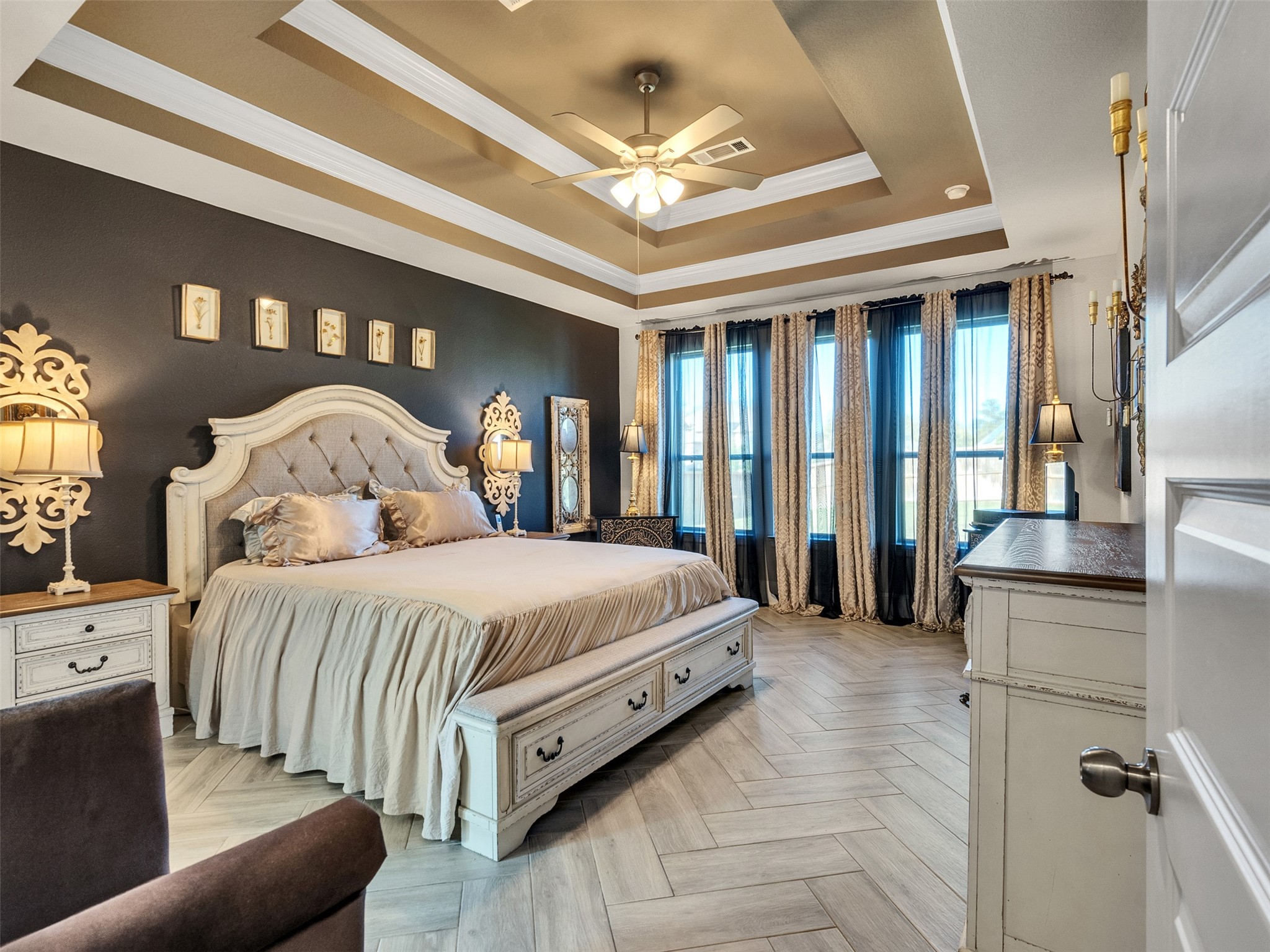 8673 Burdekin Road Magnolia, TX 77354 - Photo 23 of 48 a bedroom with a large bed and a chandelier