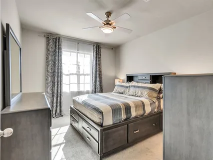 a bedroom with a bed and window