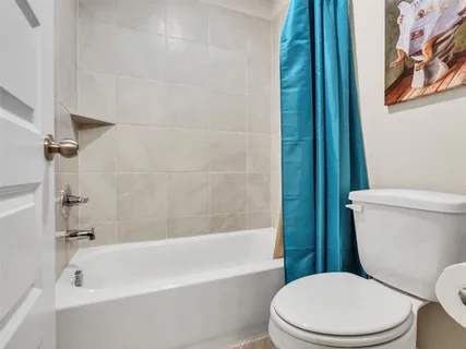 a white bath tub sitting next to a white toilet