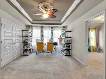 an empty room with furniture and a chandelier