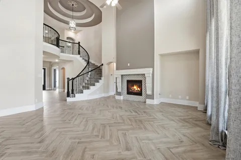 a view of an empty room with a fireplace and a window