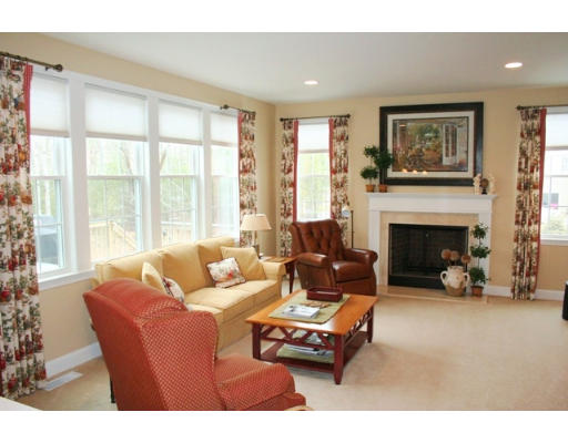 32 Howarth Drive Upton, MA 01568 - Photo 13 of 26 a living room with furniture a large window and a fireplace