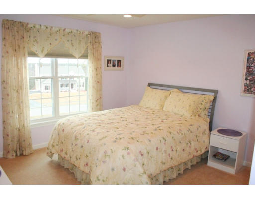 32 Howarth Drive Upton, MA 01568 - Photo 24 of 26 a bed sitting in a bedroom next to a window