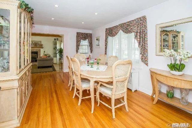 a view of a dining room with furniture a chandelier and wooden floor