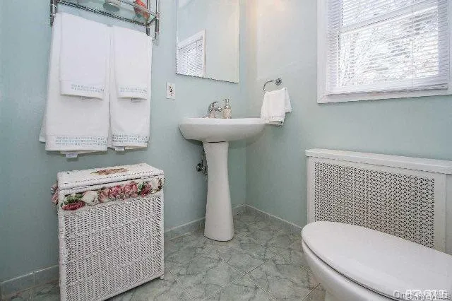 a bathroom with a sink toilet and mirror