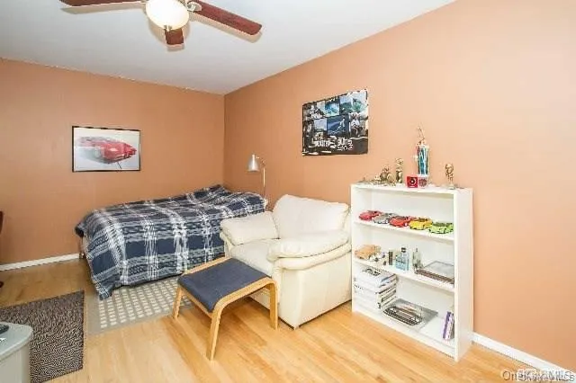 a living room with a baby crib furniture and a chandelier