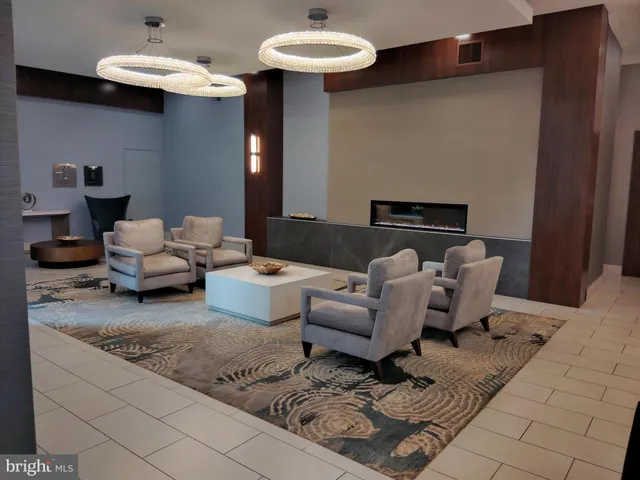 a living room with furniture and a chandelier