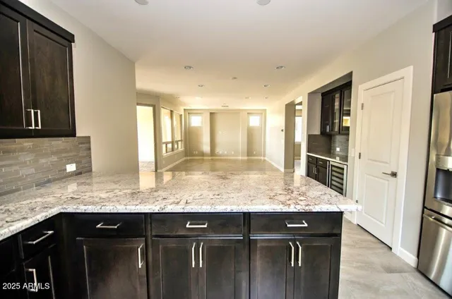 a kitchen with granite countertop cabinets and window
