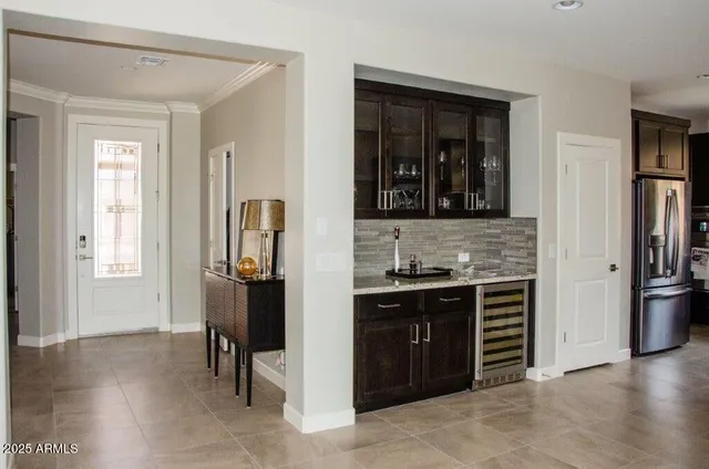a kitchen with stainless steel appliances granite countertop a refrigerator and a stove top oven