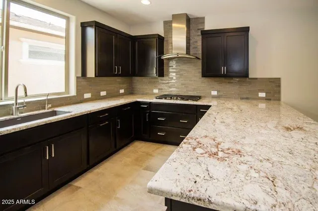 a kitchen with a sink and a stove top oven
