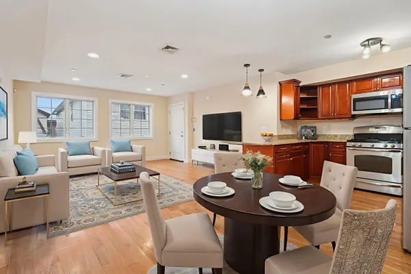 a view of a dining room with furniture and a kitchen