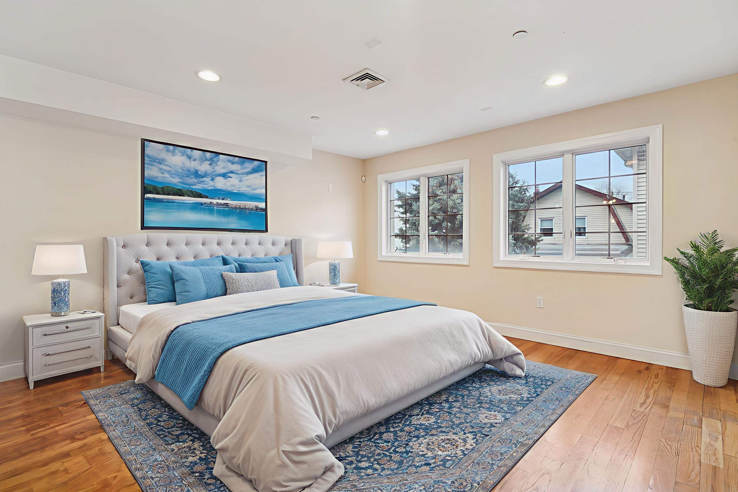 124 68th Street, Unit 203 Guttenberg, NJ 07093 - Photo 5 of 13 a bedroom with bed and wooden floor