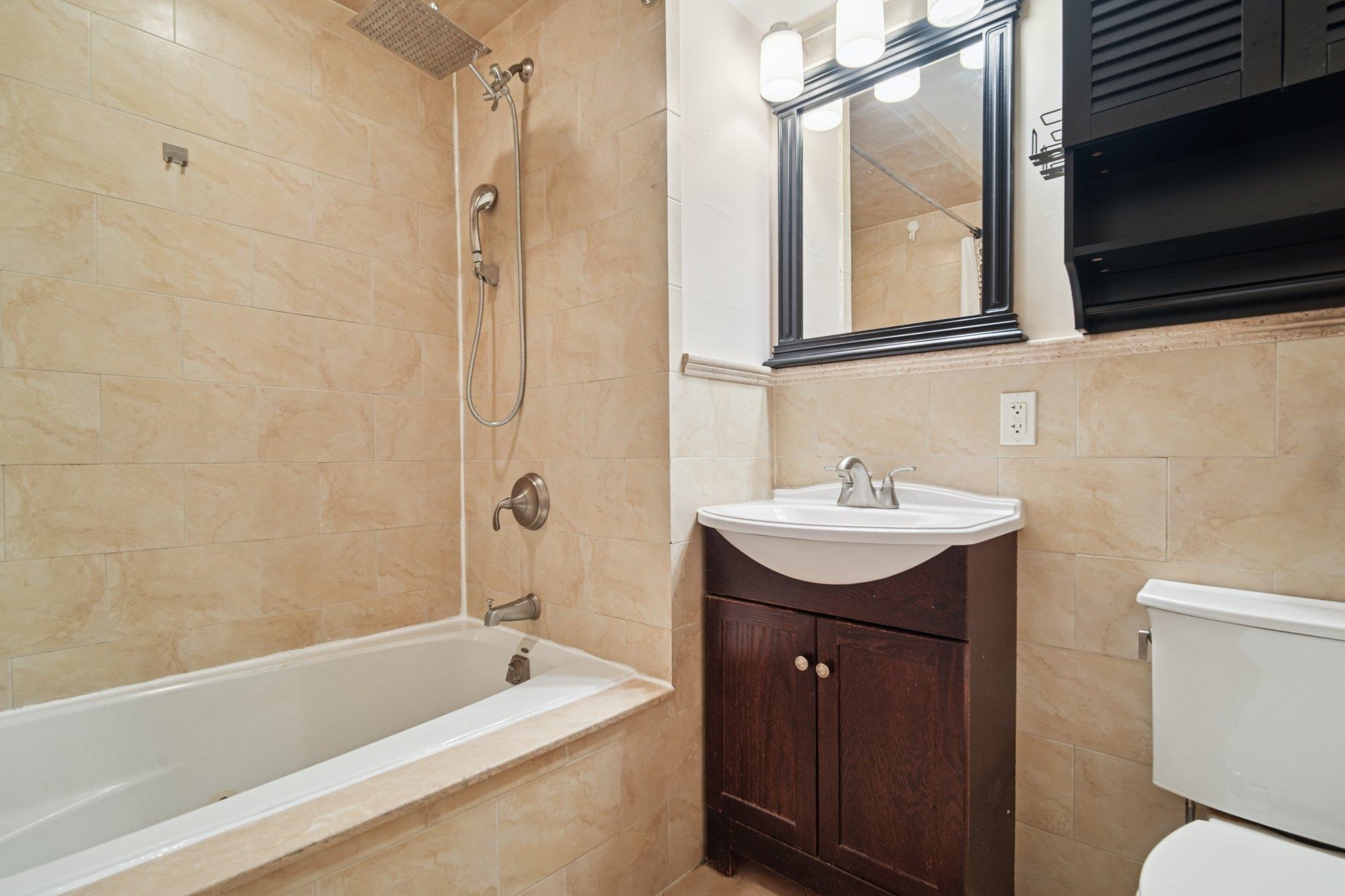 124 68th Street, Unit 203 Guttenberg, NJ 07093 - Photo 9 of 13 a bathroom with a sink toilet and shower