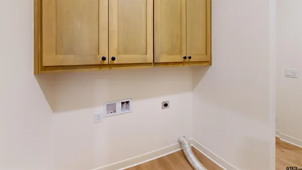 a view of a kitchen with wooden floor and cabinets