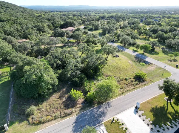 an aerial view of a houses with a yard