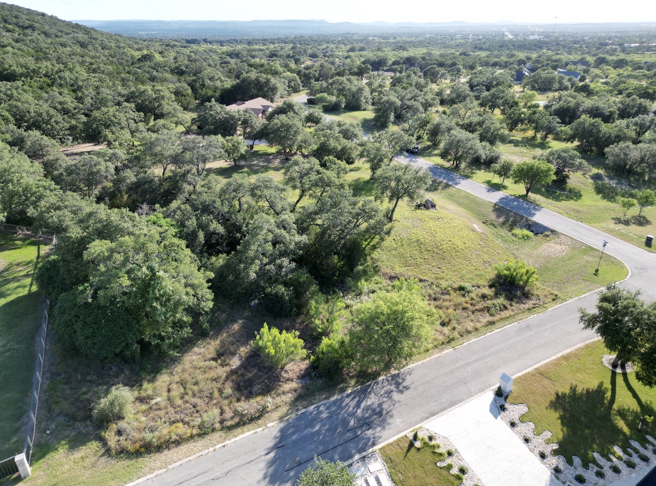 an aerial view of a houses with a yard