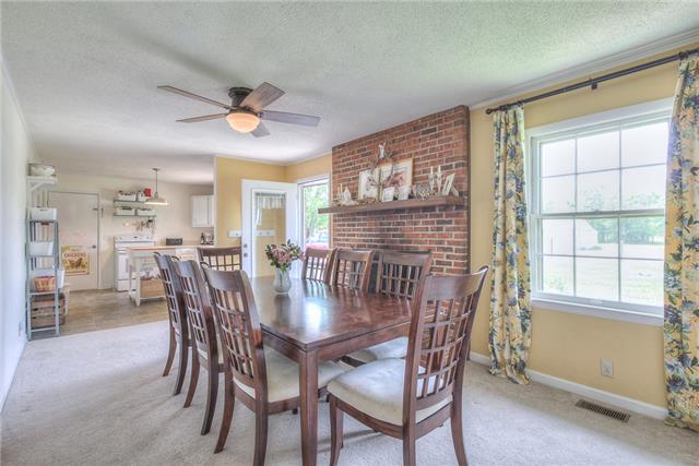 4736 Midland Road Christiana, TN 37037 - Photo 18 of 19 What a beautiful fireplace with brick hearth. This is a perfect living area for those wanting an open floor plan with access from the living area to the kitchen.