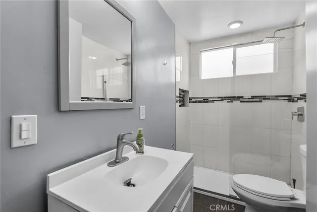 a bathroom with a sink toilet and shower