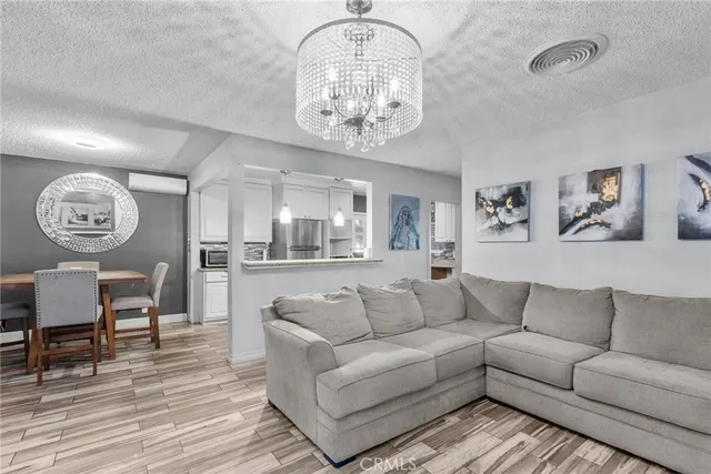 a view of a livingroom with furniture and a chandelier