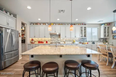 a kitchen with stainless steel appliances granite countertop a sink stove and cabinets