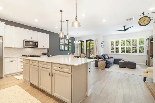 a open kitchen with stainless steel appliances granite countertop a stove and cabinets