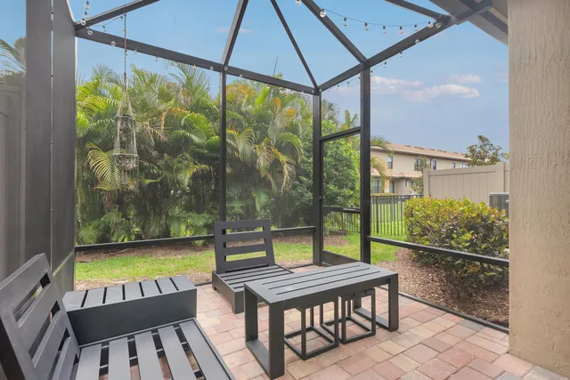 a view of a patio with a table chairs and a garden