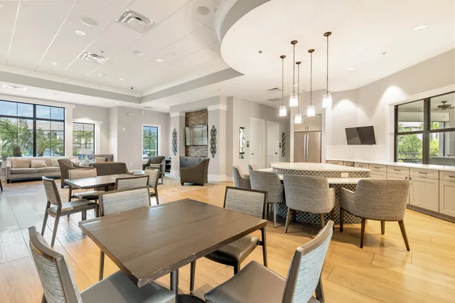 a dining room with furniture a chandelier and wooden floor