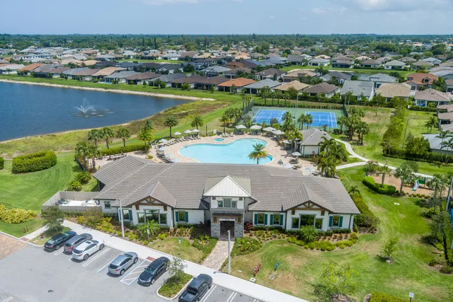 an aerial view of residential houses with outdoor space and swimming pool