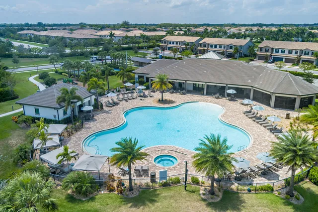 an aerial view of residential houses with outdoor space and swimming pool