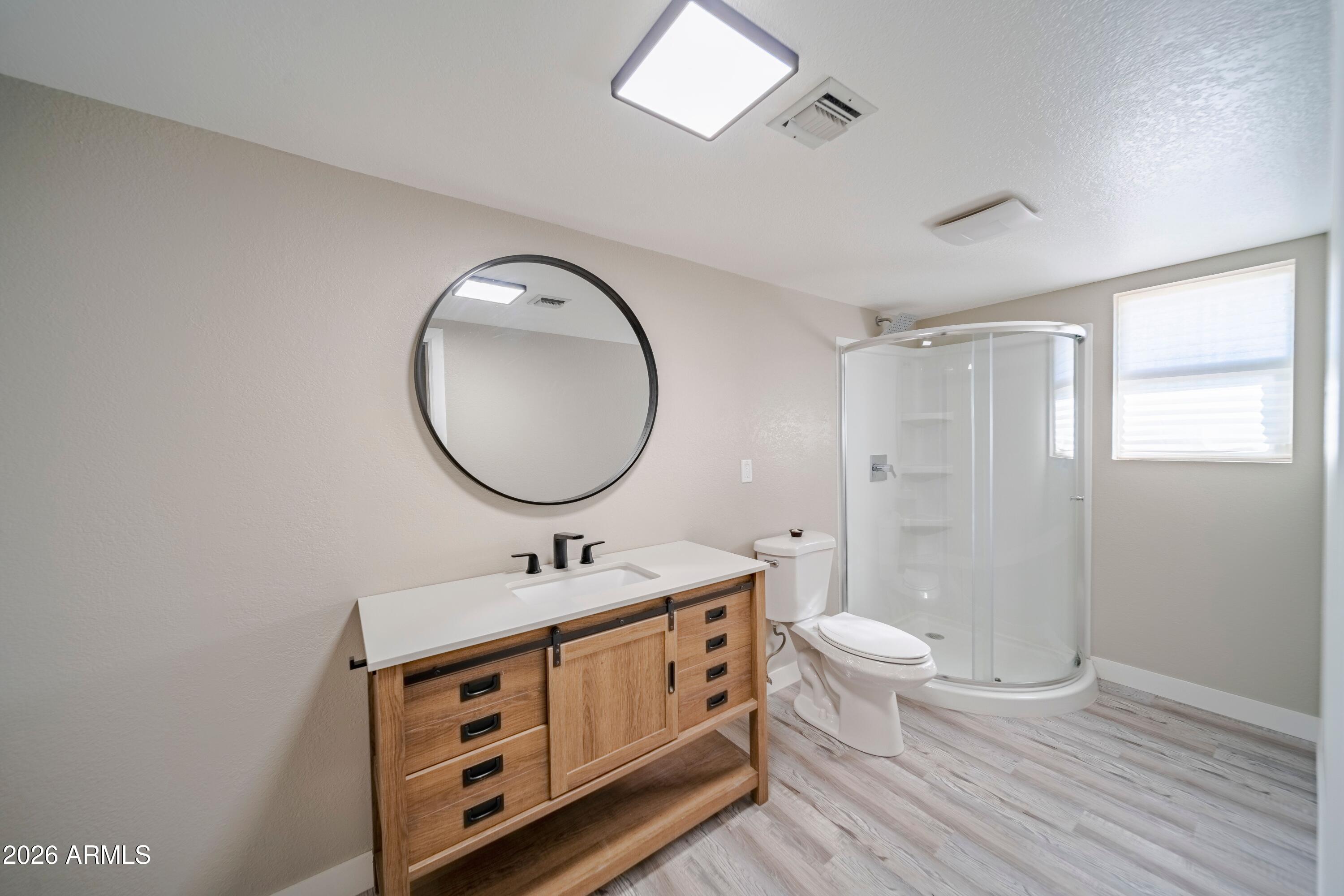 51718 West Donald Road Aguila, AZ 85320 - Photo 17 of 59 a bathroom with a double vanity sink toilet mirror and shower