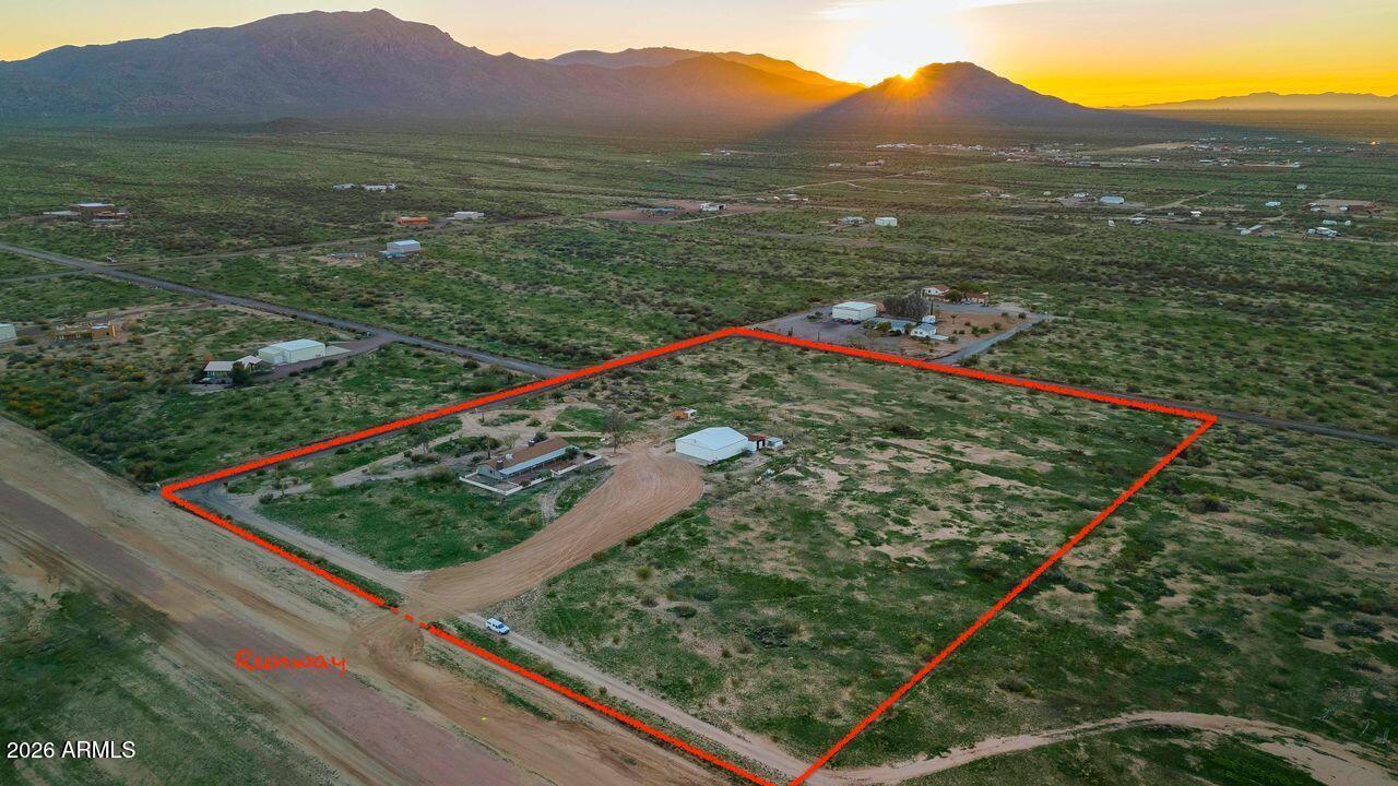51718 West Donald Road Aguila, AZ 85320 - Photo 2 of 59 a view of a lush green space with a mountain
