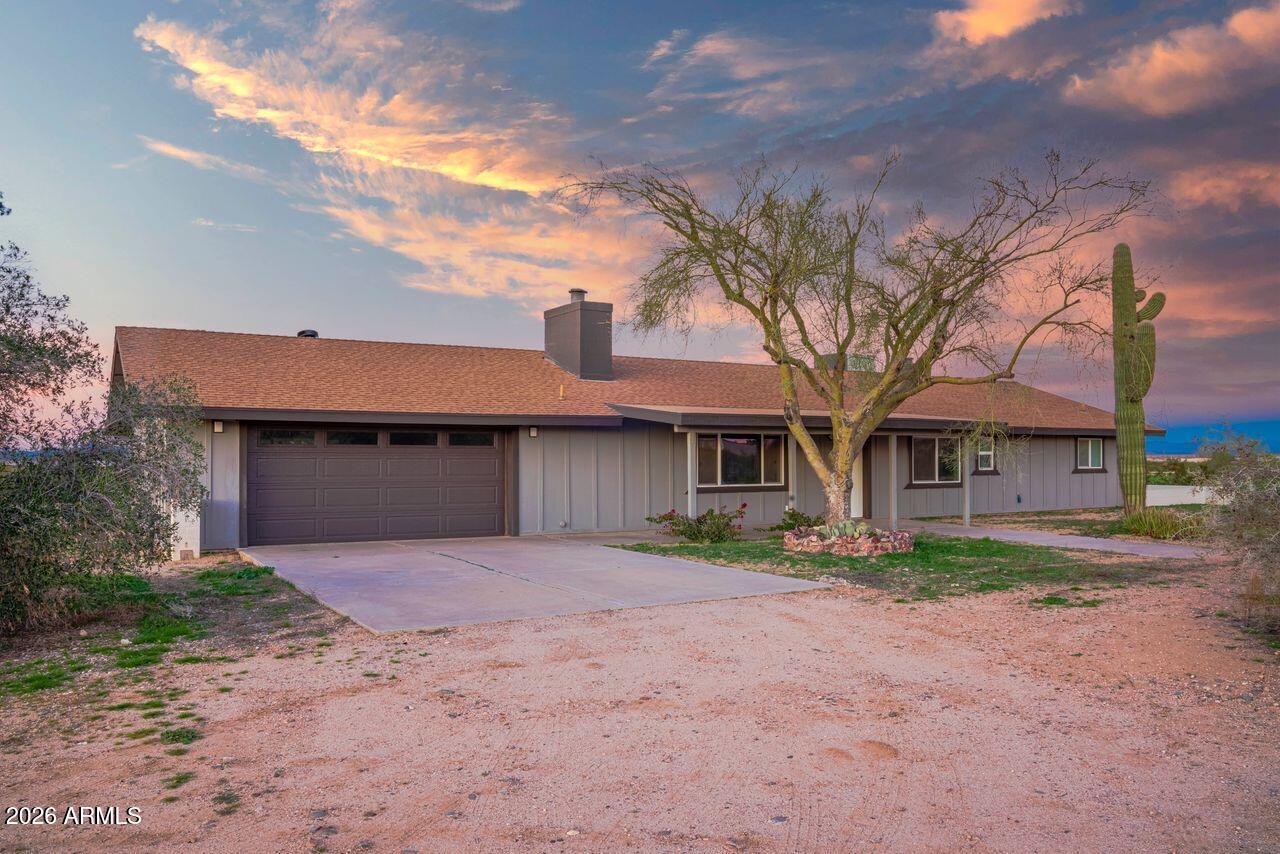 51718 West Donald Road Aguila, AZ 85320 - Photo 30 of 59 a front view of a house with a yard and a garage