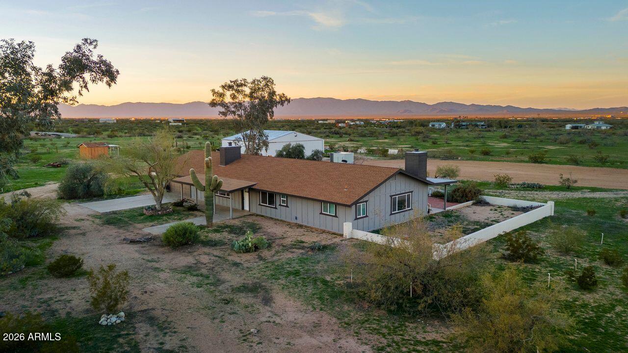 51718 West Donald Road Aguila, AZ 85320 - Photo 35 of 59 a aerial view of a house with a garden and mountains