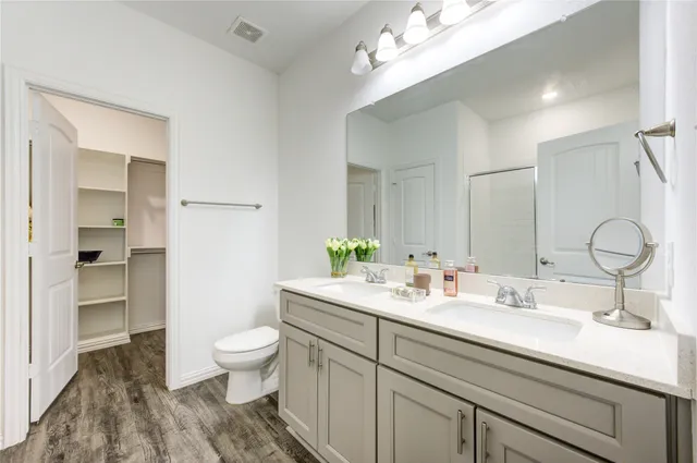 a bathroom with a sink a toilet and a mirror