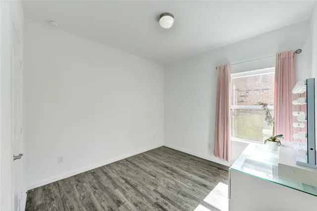a view of a room with wooden floor and windows