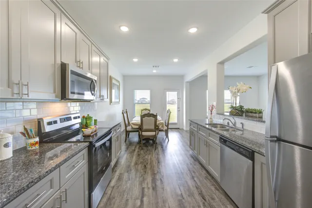 a kitchen with stainless steel appliances granite countertop lots of counter top space